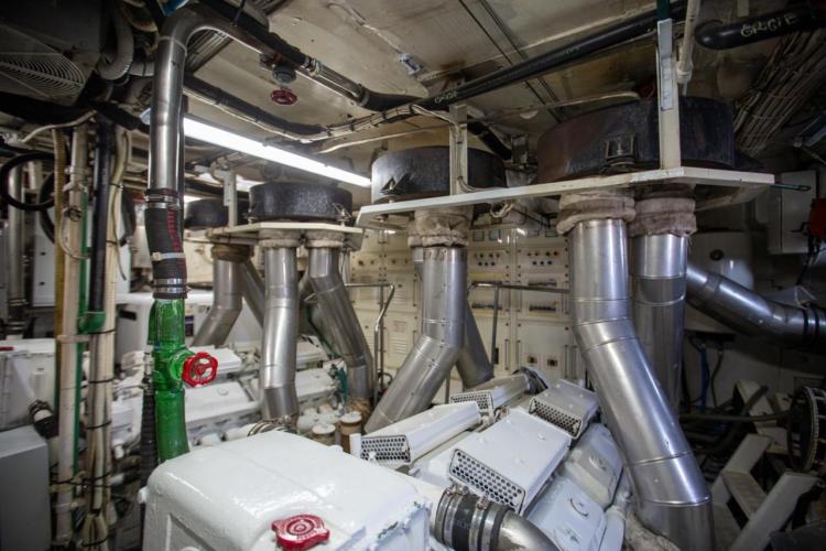 Engine room of 1972 Benetti 33 yacht with complex piping and machinery.