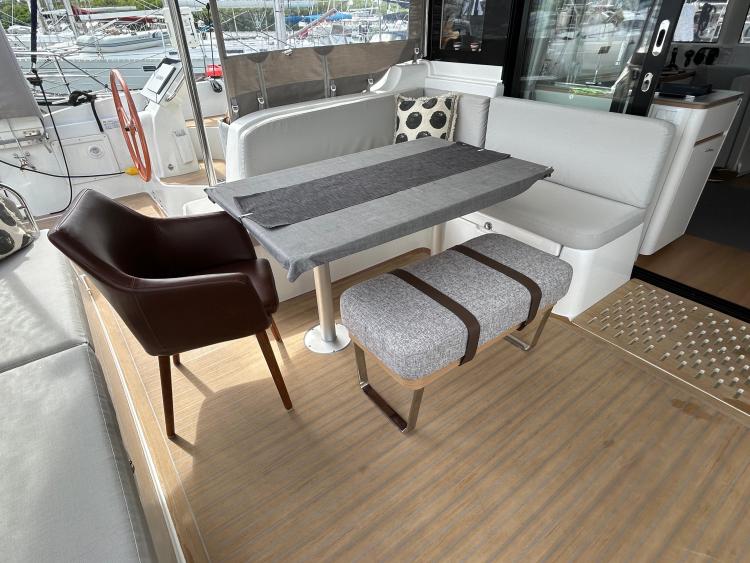 Luxurious 2024 Excess 14 yacht interior with modern seating and dining area.