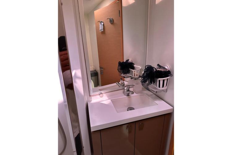 Bathroom sink area on 2016 Fountaine Pajot Ipanema 58 yacht, featuring modern fixtures.