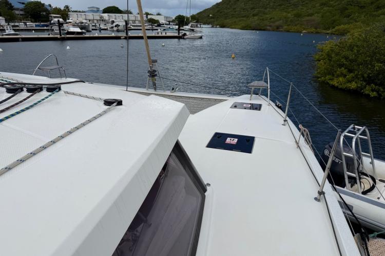 2020 Fountaine Pajot Astrea 42 catamaran docked in a serene marina setting.