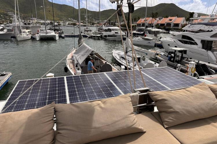 2016 Fountaine Pajot Ipanema 58 catamaran with solar panels docked in a marina.