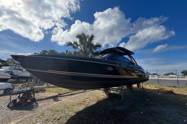 2018 Formula 350 Crossover Bowrider boat on display under a clear blue sky.