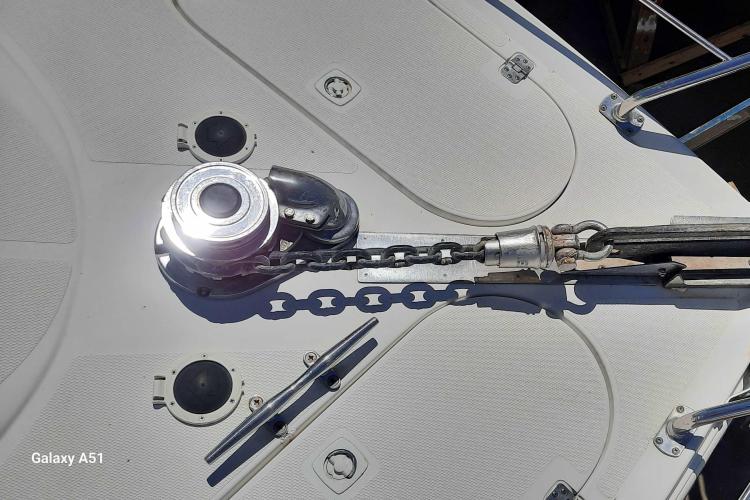 Deck of 2000 Carver 530 Voyager Pilothouse with anchor chain and winch.