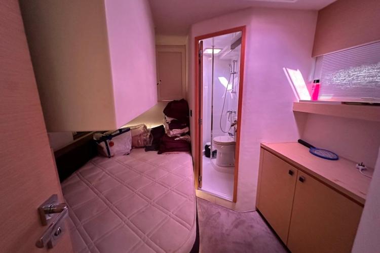 Interior cabin of 2016 Fountaine Pajot Ipanema 58 yacht with bed and ensuite bathroom.