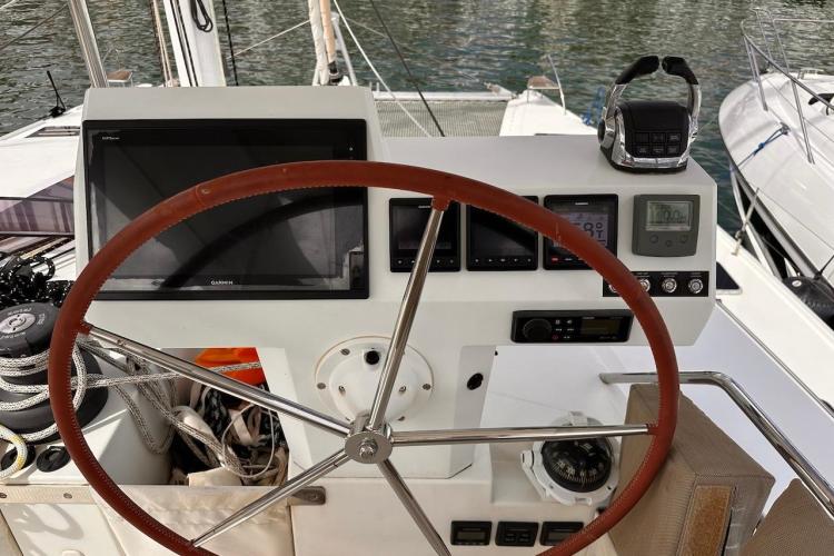 Helm of 2016 Fountaine Pajot Ipanema 58 catamaran with navigation instruments and steering wheel.