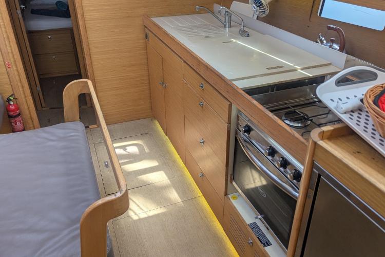 Modern kitchen interior of 2017 Dufour 460 Grand Large yacht with wooden cabinetry.
