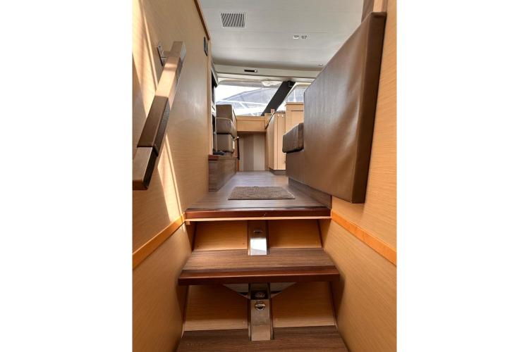 Interior view of 2016 Fountaine Pajot Ipanema 58 yacht, featuring wooden stairs and seating.