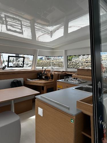2024 Excess 11 yacht interior with modern kitchen and dining area.