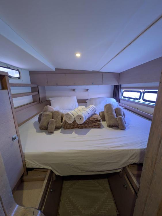 Luxurious cabin interior of 2012 Catana 55 yacht with neatly arranged towels.