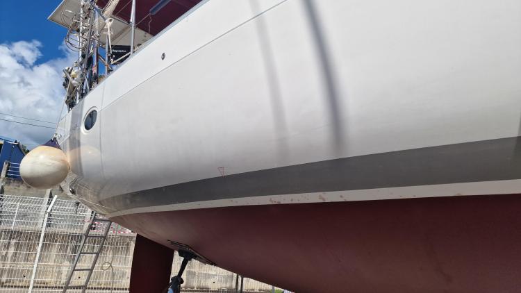 2007 Elan Impression 434 sailboat on dry dock, showing hull and fender.