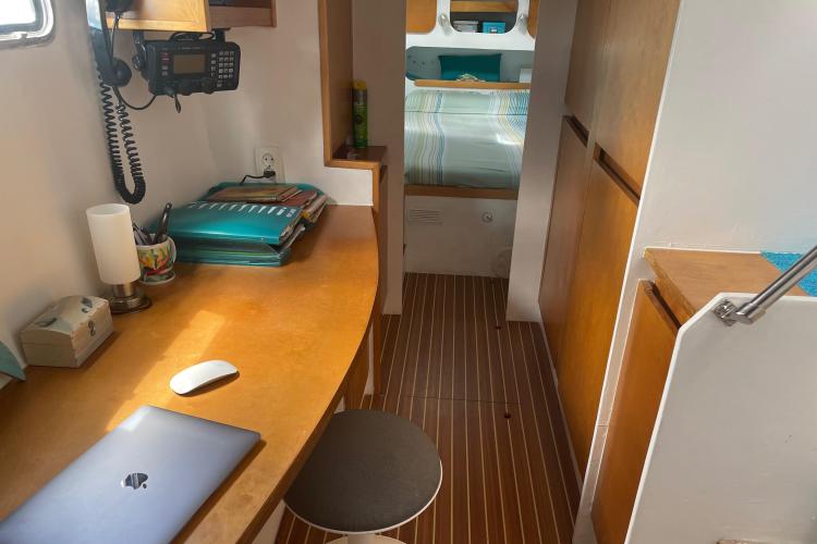 Compact cabin interior with desk, chair, and bed in Custom KSENIA 149, 2010 model.