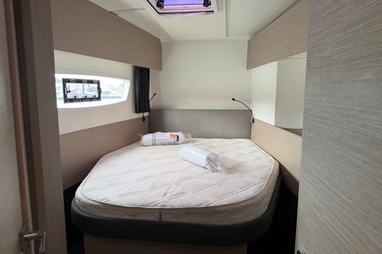 Cozy bedroom in 2020 Fountaine Pajot Astrea 42 catamaran with modern design and natural light.