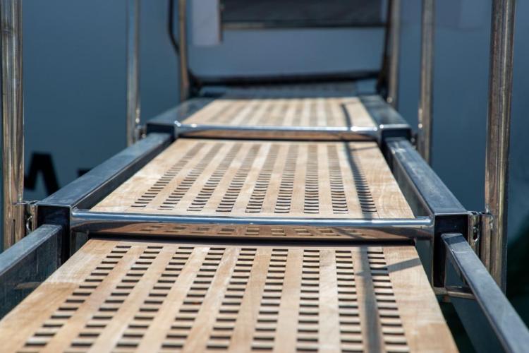 Close-up of a wooden gangway on a 1972 Benetti 33 yacht.