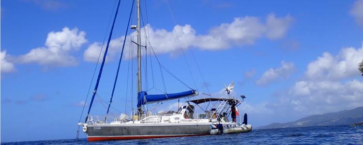 Sailboat "Custom Patago 40" 2019 on calm sea under blue sky with clouds.