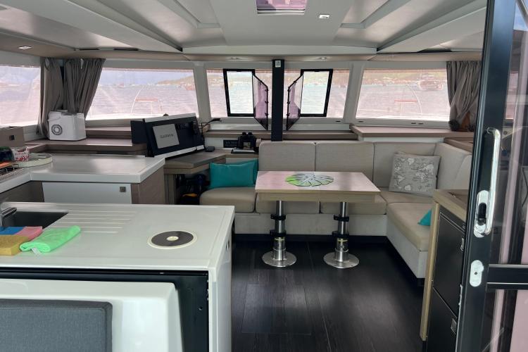 Interior of 2023 Fountaine Pajot Astrea 42 Catamaran, featuring modern seating and navigation equipment.