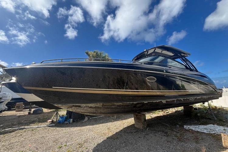 2018 Formula 350 Crossover Bowrider boat on land under a clear blue sky.