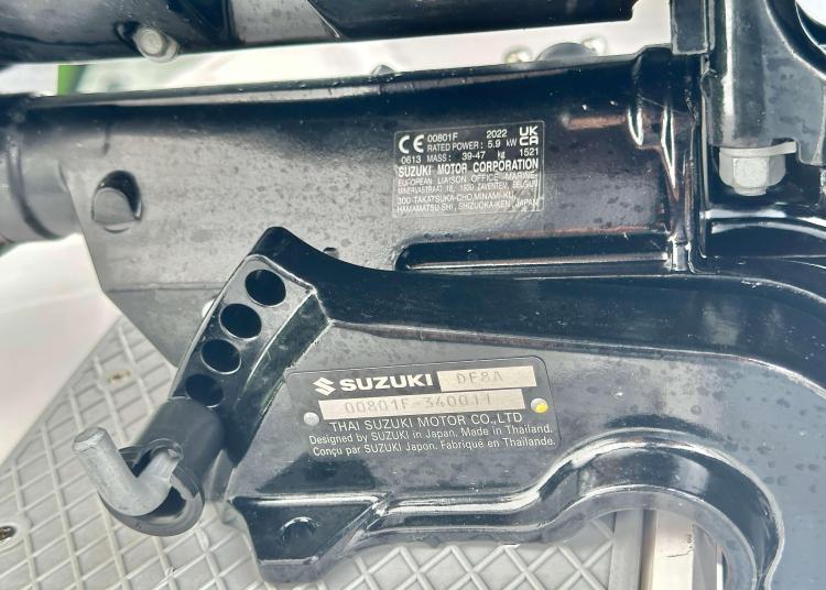 Outboard motor detail on a 2023 Lagoon 46 catamaran, featuring Suzuki branding and specifications.