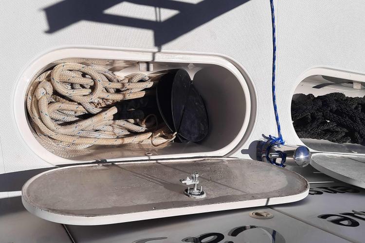Storage compartment on 2000 Carver 530 Voyager Pilothouse with ropes and equipment.