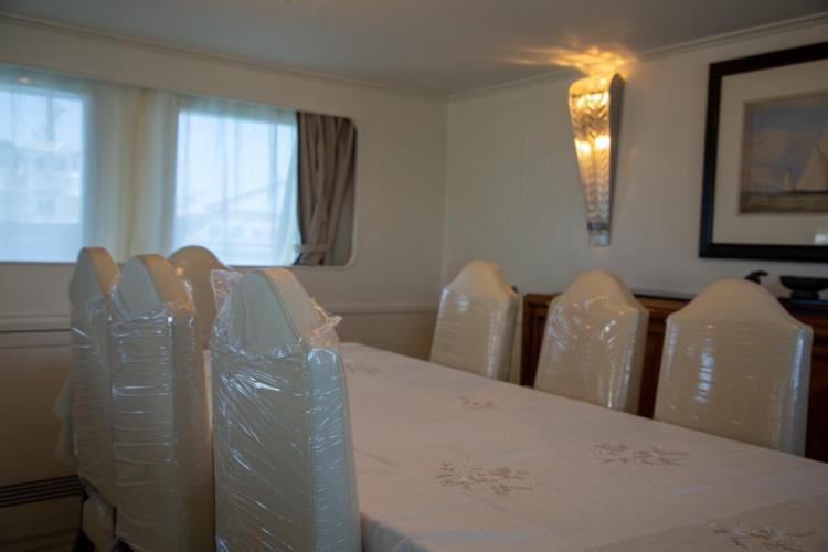 Dining area on a 1972 Benetti 33 yacht with elegant table and chairs.