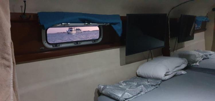 Cabin interior of 1999 Fountaine Pajot Bahia 46 catamaran with window view of the sea.