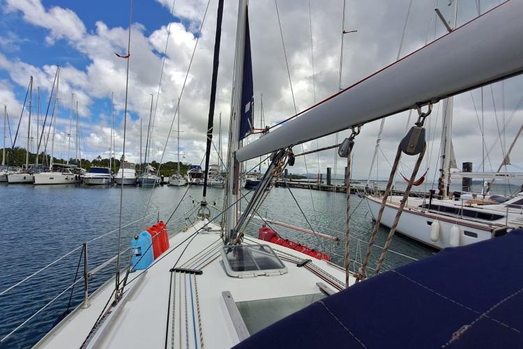 Jeanneau Sun Odyssey 37 sailboat docked in marina, 2000 model, under cloudy sky.