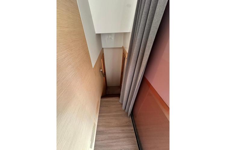 Narrow hallway inside 2016 Fountaine Pajot Ipanema 58 yacht, featuring wood paneling and curtains.