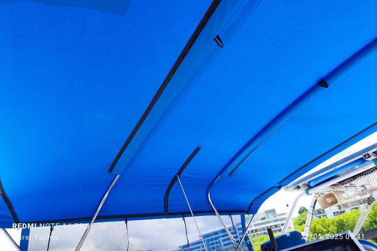 Blue canopy of a 2019 Custom Patago 40 boat with metal supports.