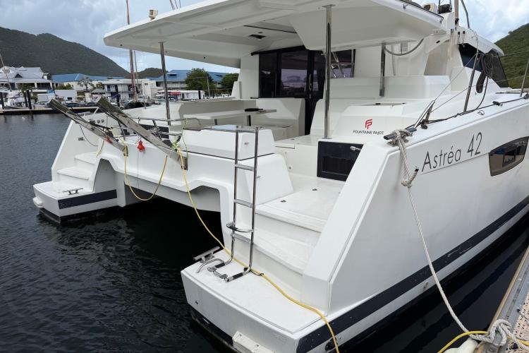 2020 Fountaine Pajot Astrea 42 catamaran docked at marina, showcasing sleek design and spacious deck.