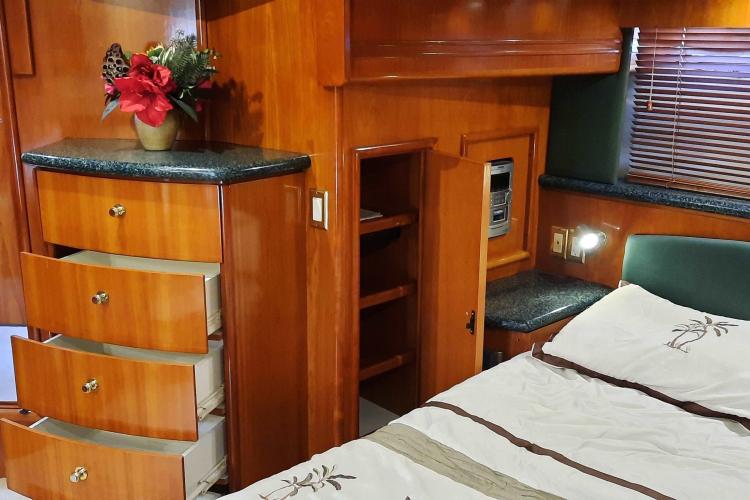 Luxurious interior of 2000 Carver 530 Voyager Pilothouse with wood cabinetry and floral decor.