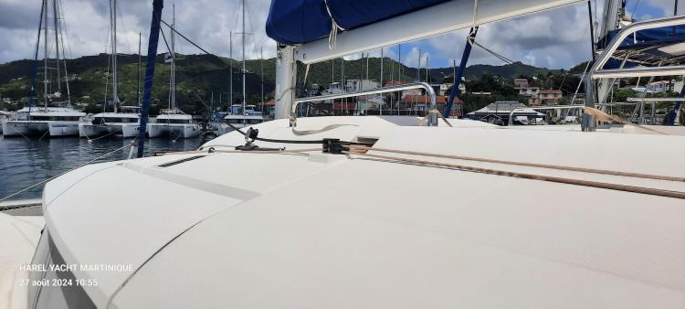 2017 Fountaine Pajot SABA 50 catamaran docked in a marina with scenic background.