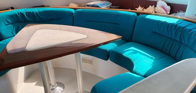 Interior of 1999 Fountaine Pajot Bahia 46 with turquoise seating and triangular table.