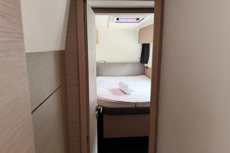 Interior cabin view of 2020 Fountaine Pajot Astrea 42 catamaran, featuring a cozy bed.