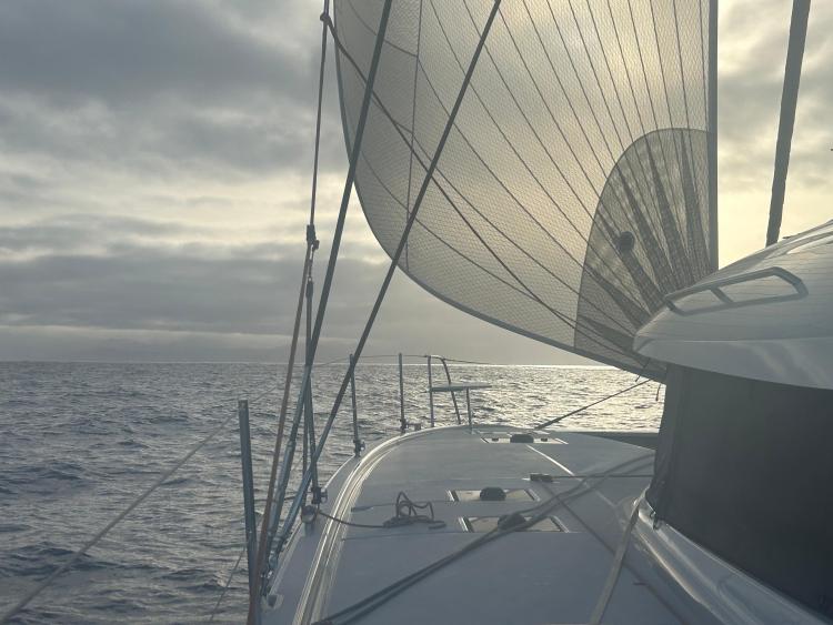 Sailing on a 2024 Excess 14 catamaran with dramatic ocean and sky backdrop.