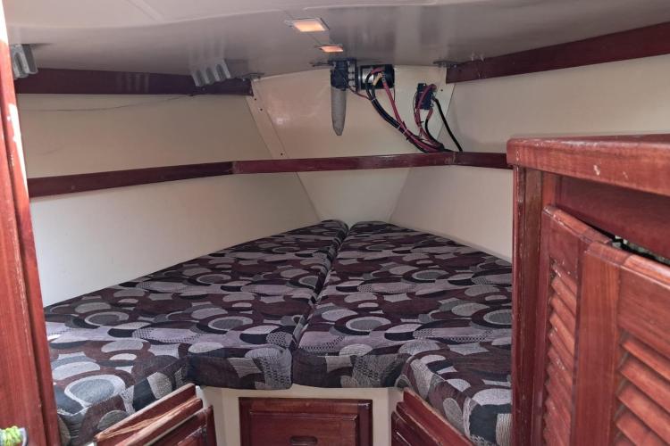 Interior cabin of 1986 Dufour CATALINA sailboat with patterned cushions.