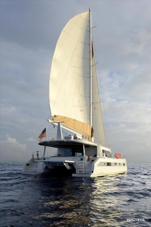 2019 Squalt Marine CK 64 catamaran sailing on open sea with full sails.