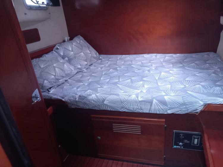 Cozy cabin interior of 1999 Fountaine Pajot Bahia 46 with patterned bedding.