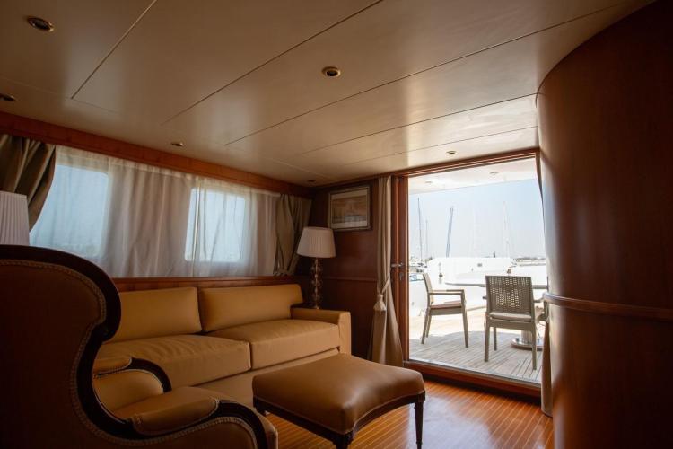 Luxurious interior of 1972 Benetti 33 yacht with elegant seating and outdoor view.