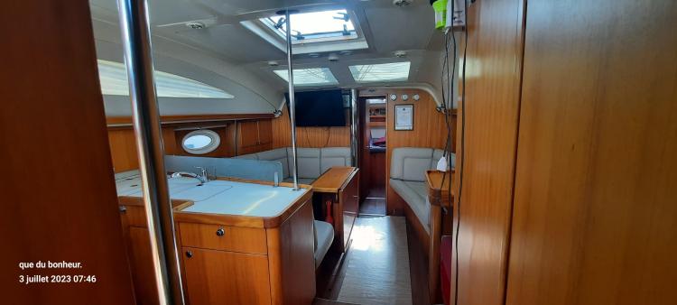 Interior of 2007 Elan Impression 434 yacht with wooden furnishings and seating area.