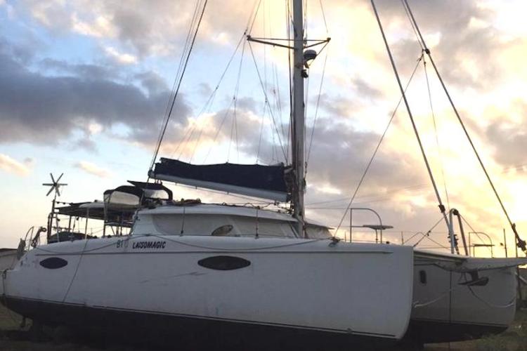 2009 Fountaine Pajot Orana 44 catamaran against a sunset sky.