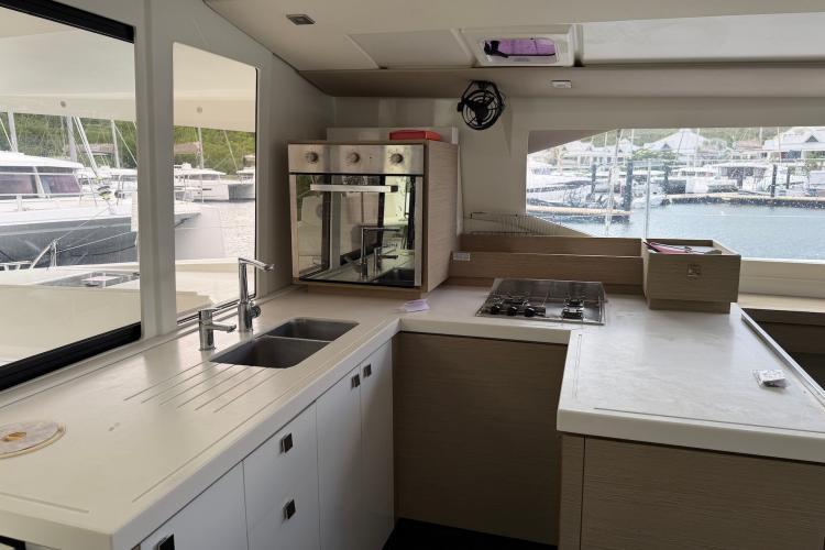 Modern kitchen interior of 2020 Fountaine Pajot Astrea 42 yacht with marina view.