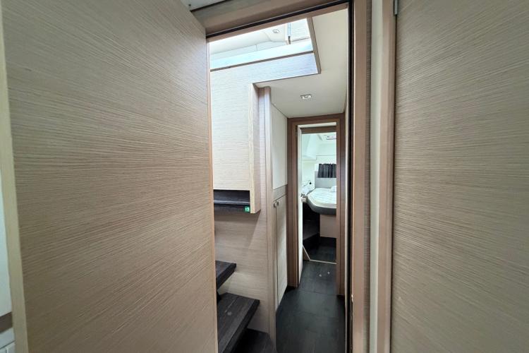 Interior view of 2020 Fountaine Pajot Astrea 42 catamaran, featuring modern wood finishes and cozy cabin.