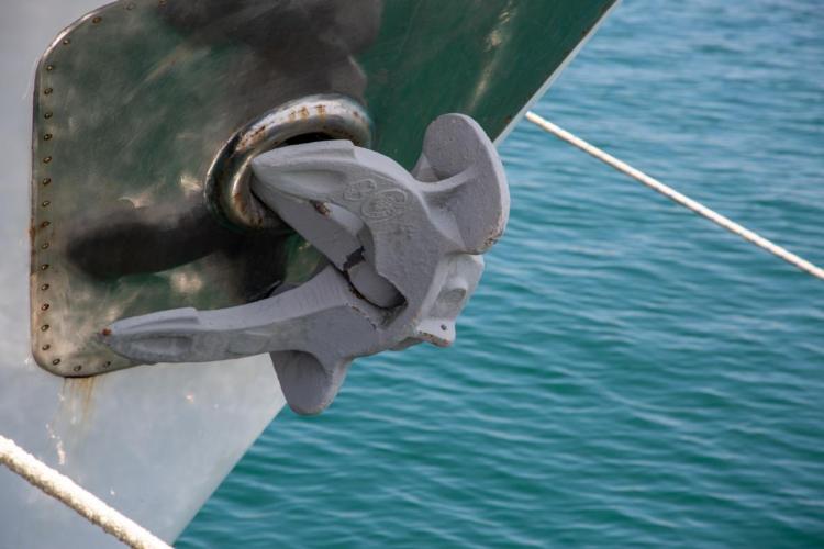 Anchor of 1972 Benetti 33 yacht against blue ocean backdrop.