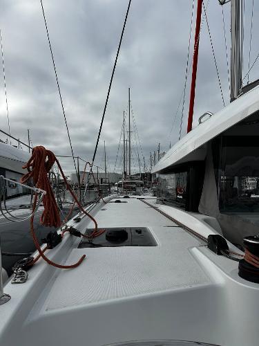 2024 Excess 11 sailboat deck view with ropes and overcast sky.