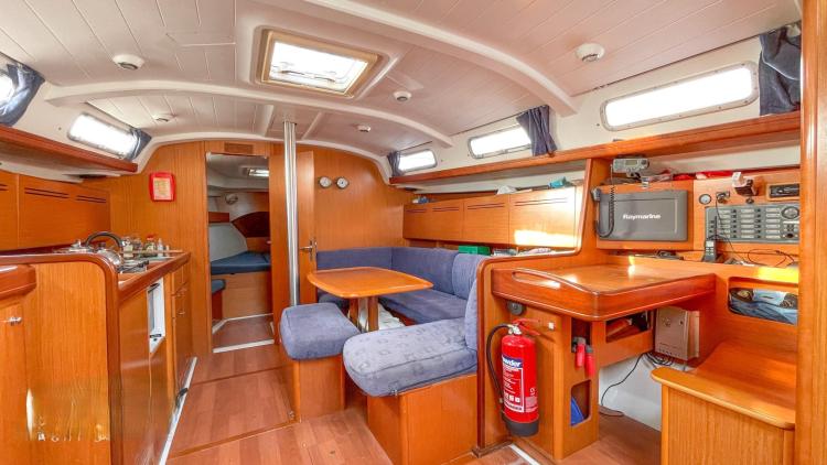Interior of 2005 Beneteau Cyclades 43.3 yacht with wood finish and seating area.