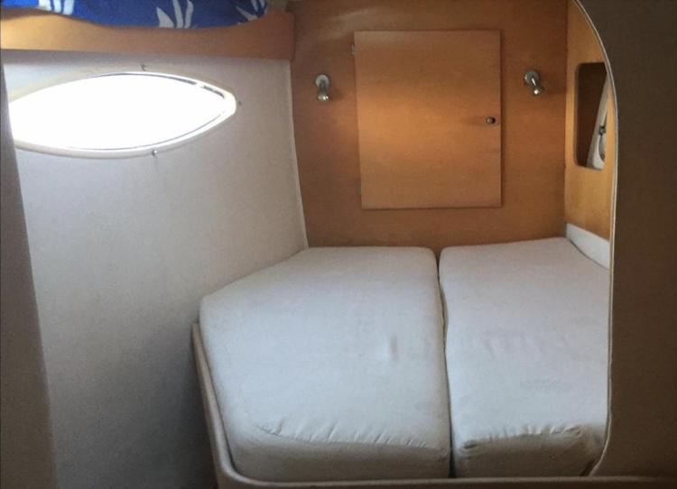 Cabin interior of 2009 Fountaine Pajot Orana 44 catamaran with twin beds and porthole.