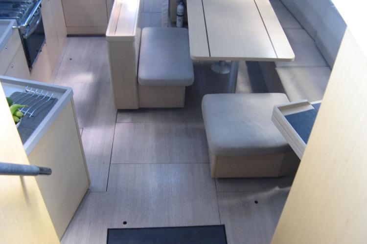 Interior of 2019 Beneteau Oceanis 46.1 yacht with modern dining area and seating.