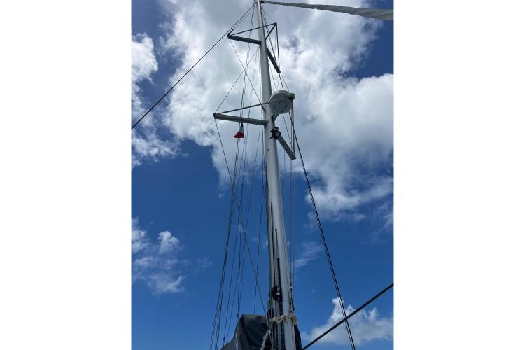 Mast of 2023 Fountaine Pajot Astrea 42 Catamaran against blue sky and clouds.