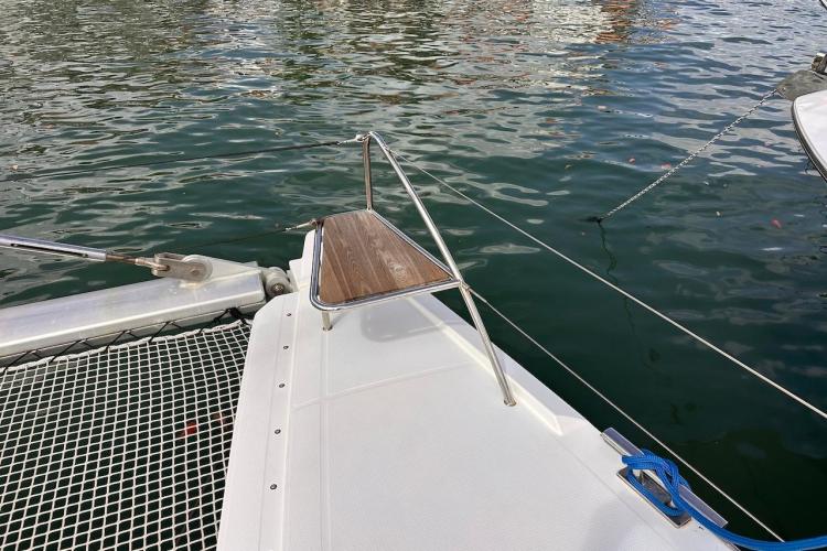 Deck view of 2016 Fountaine Pajot Ipanema 58 catamaran, featuring netting and water.