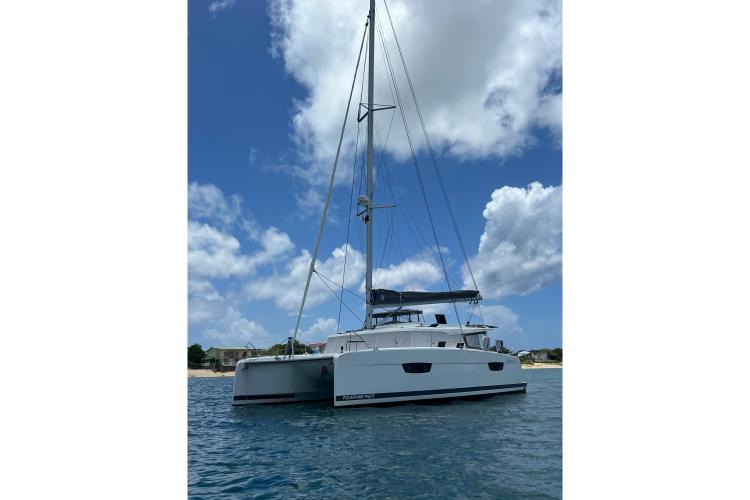 2023 Fountaine Pajot Astrea 42 Catamaran sailing on a sunny day with blue skies.