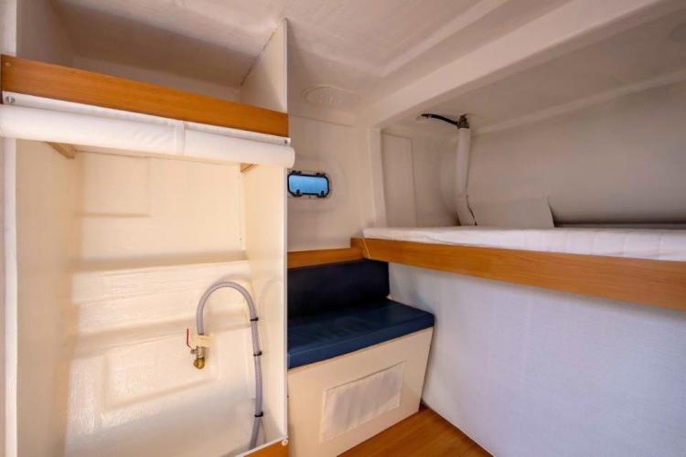 Custom DAYCHARTER 2026 interior with bunk bed, seating, and storage.